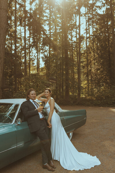 Wedding couple posing in front of their cool car in Washington, captured by Bare Bones Photo