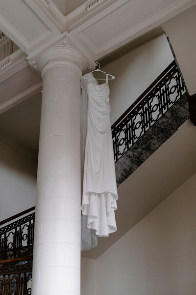 wedding dress hanging from ceiling for gorgeous detail shot