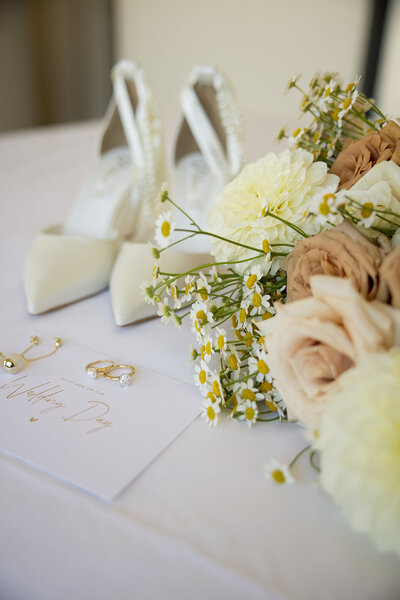 detail shot of brides shoes and bouquet on wedding day