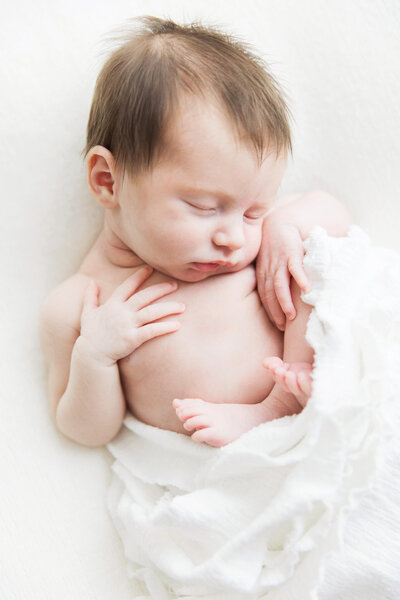 newborn wrapped in white blanket