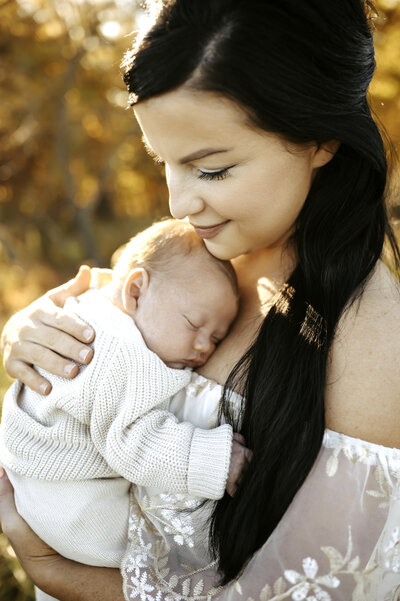 Outdoor lifestyle newborn photo with mom and baby