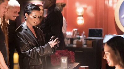 Demi Lovato and Evan Ross viewing custom engraved perfume bottle at Ashley Benson's launch party