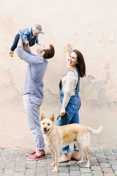 Mom Dad baby and dog playing in the streets of Vienna Virginia