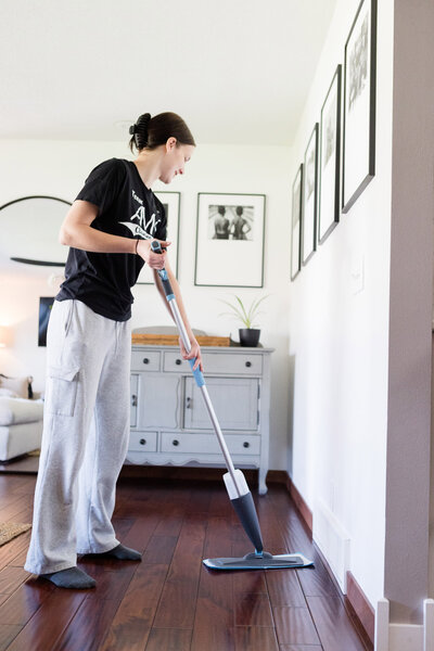 Professional cleaner mopping hardwood floors