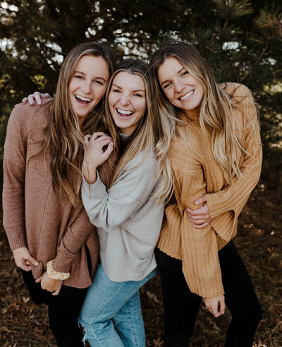 Pulley Girls hugging and smiling at the camera