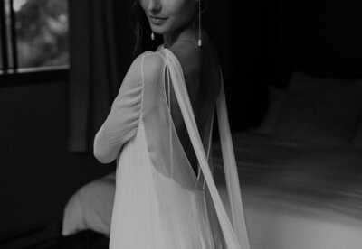 Bride looks back over her shoulder as she gets ready for her Ouray elopement