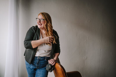 A women in glasses smiling.