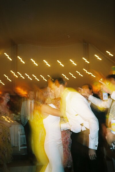 Candid moment of the couple dancing with their guests at The Cracker Factory in Geneva, NY.