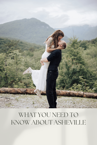 A couple embraces with mountains in the background.