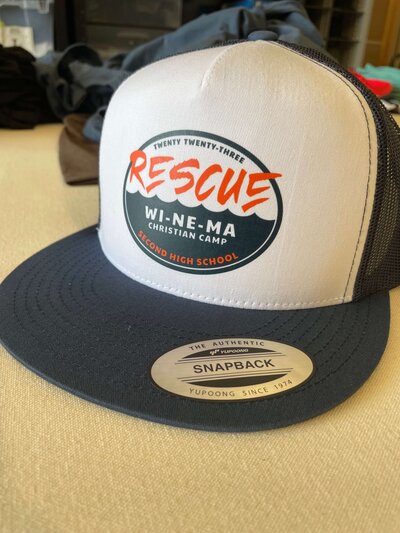 Rescue WI-NE-MA Christian Camp second high school design on yupoong snapback white and navy hat.