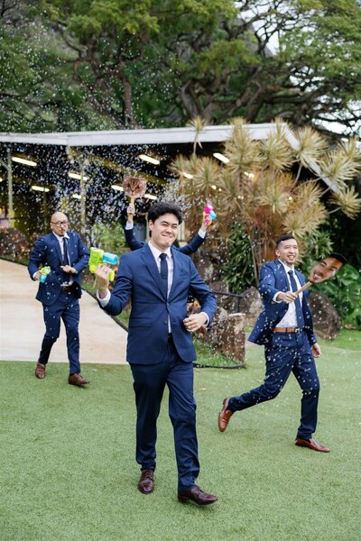 Wedding guests walking together and holding bubble makers and smiling 