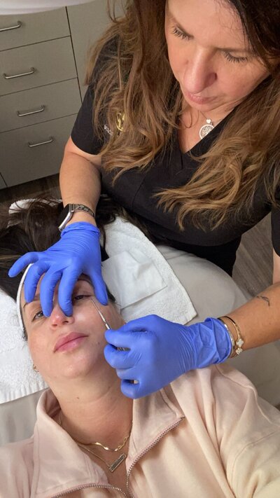 Jennifer doing a dermaplaning facial.
