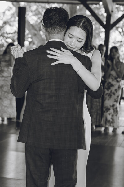 Bride crying during emotional father-daughter dance at wedding reception