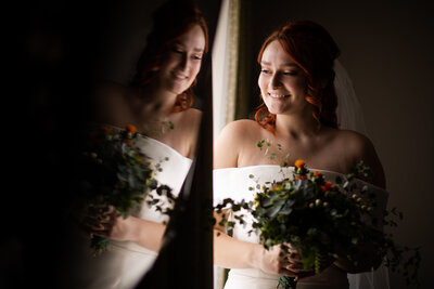 Bride looking out the window on her Flint MI wedding day