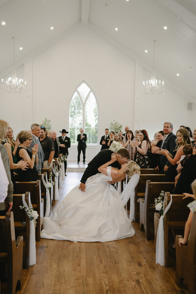 bride and groom kissing at their OKC chapel wedding ceremony