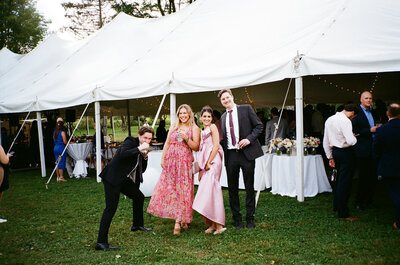 Candid guest moment at tented reception by Pennsylvania wedding photographer