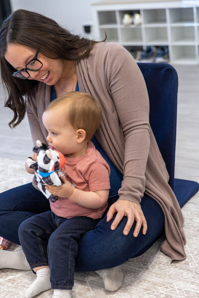 Woman smiling as she holds her baby