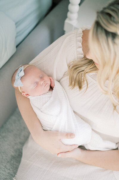 Expectant mother, cradling her baby bump delicately in beautiful lace dress with hydrangeas in hand, photographed by Edmonton Maternity Photographer, Kahla Kristen