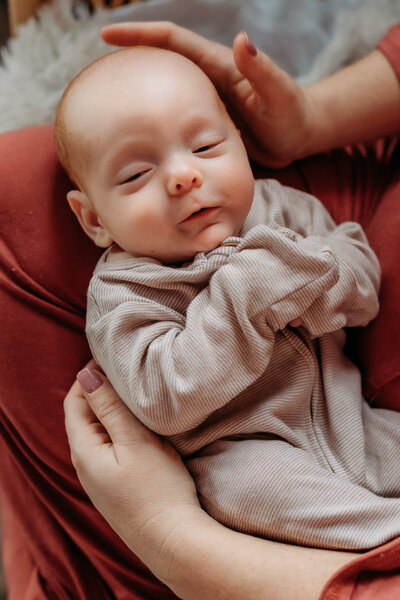 Mother and baby cozy and nursing for motherhood photoshoot