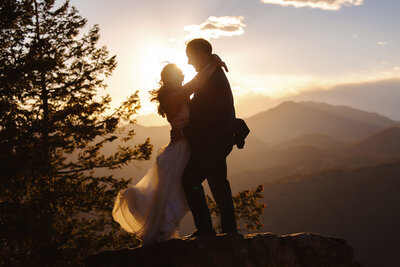 Silhouette sunset photos taken near Denver Colorado by a Breckenridge wedding photographer. True to life editing style and a candid moment shared by the couple. 