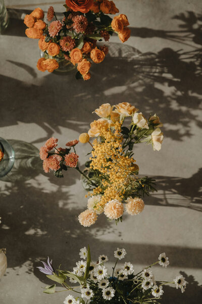 Delicate yellow and peach flowers arranged under warm sunlight