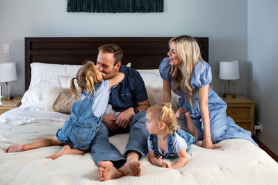 Playful moment during an in-home newborn family photoshoot.