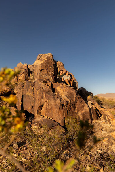 Couple posing on rocky formations during a Utah session, photographed by Lamblight Photography