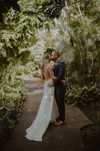 Couple kisses in a rainforest in Kauai