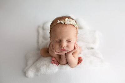 newborn baby girl on mint background