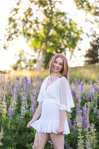 Girl in white dress in Lupin field | Senior Photography Session
