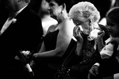 Luxury Portraits by Moving Mountains Photography in NC - Black and white photo of family crying at the wedding ceremony