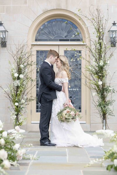 couple embracing in front of window