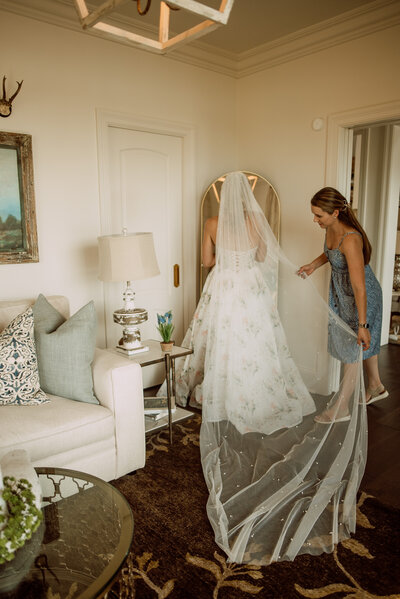 Wedding planner fixing the bride's veil