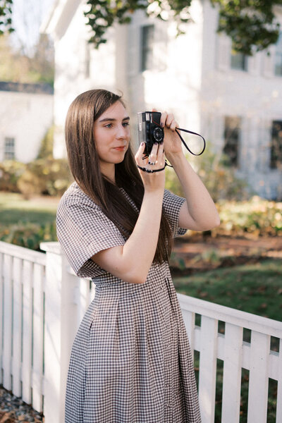 woman takes a picture of downtown woodstock vermont