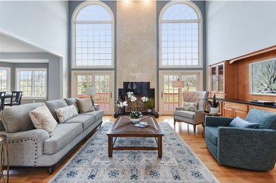Minimalist staging in a vacant living room to highlight natural light from large windows and room dimensions