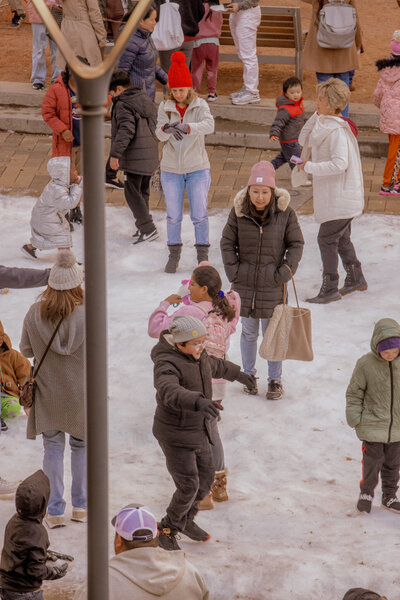 Lots of kids and families playing in the snow