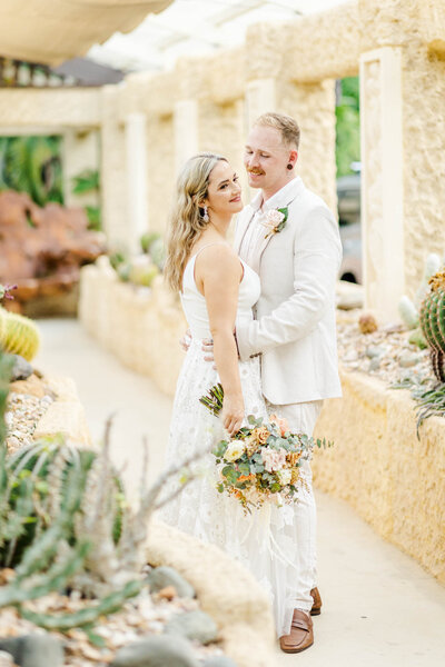 bride and groom standing for bridal portraits during thei villa botanica wedding