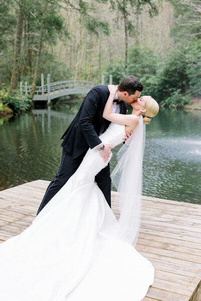 Bride and Groom with florals by Petal and Fern WNC  at The Farm at Old Edwards Inn by Maddie Moore Photo