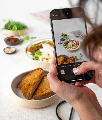 An image of an iphone capturing a food setting and showing that food photography can be done by any mobile device