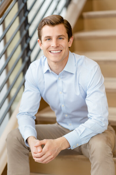 Smiling Man poses for professional headshot with JM Visual Art Co