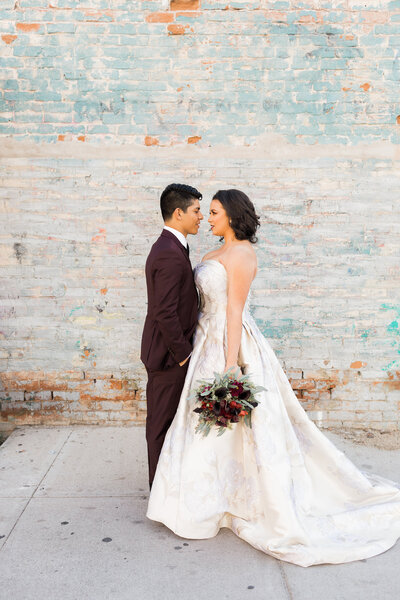 Couple smiles off into the distance while outside for photo shoot