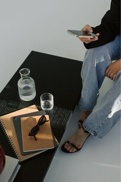 A Kmotion employee on the phone, with paperwork for a Showit website design project on a table.

