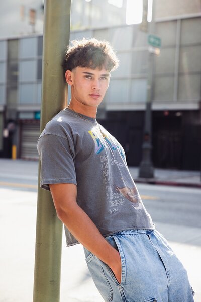 Senior pictures of a teen boy in Los Angeles with editorial fashion styling and city backdrop.

