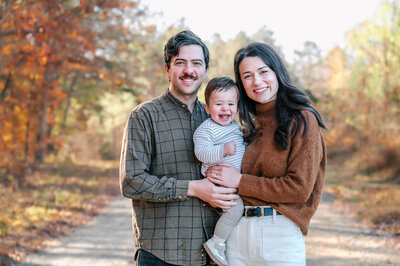 a family of five sitting on a park at coker arboretum and having their photo taken by rosa ashdown