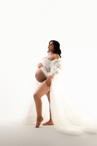 posed in a star goddess gown tasteful portrait in studio on brown