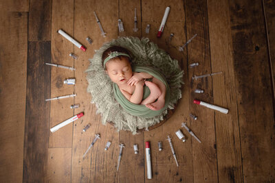 baby surrounded by ivf needles, hamilton newborn photography studio