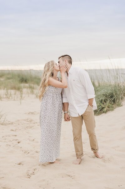 Wedding Photographer & Elopement Photographer Husband and wife kiss on east bay beach for engagement