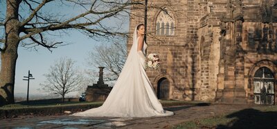 Eleghant bride outside Lancaster Priory Church of Saint Mary taken by wedding videographer Anthony Horseman