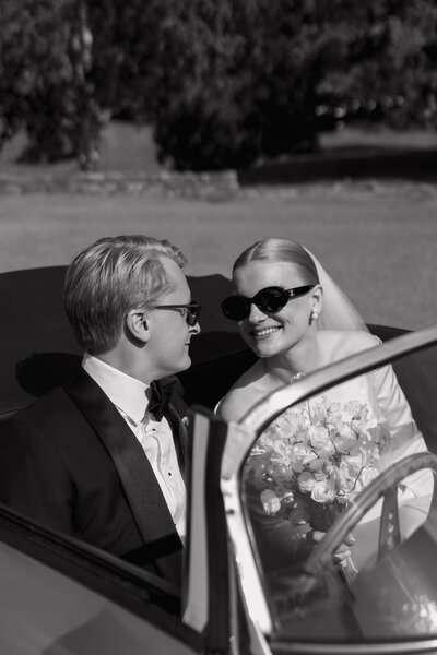 Wedding photographer captures couple taking a stroll hand in hand at their french chateau wedding.