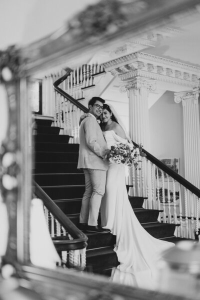 Couple on the stairs holding flowers